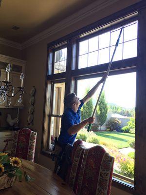 Using a pole to get those high windows cleaned.