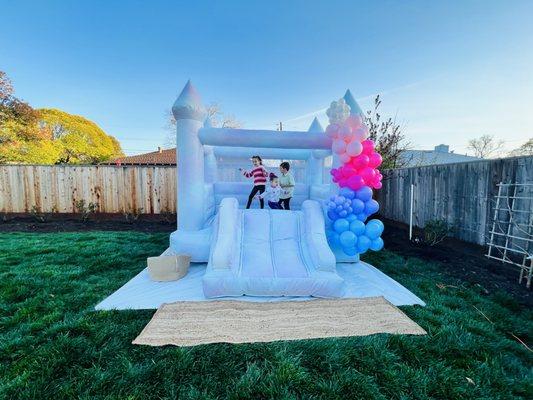 The Tutti Fruitti Bop bounce house with a 6-foot balloon garland