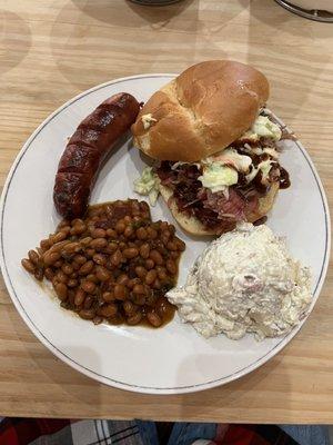 Pulled pork sandwich, mild sausage, beans and potato salad.  All very good.