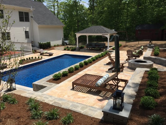 Designed and installed dramatic patio, pool surround and walls with travertine stone, liberty hill granite and bluestone.