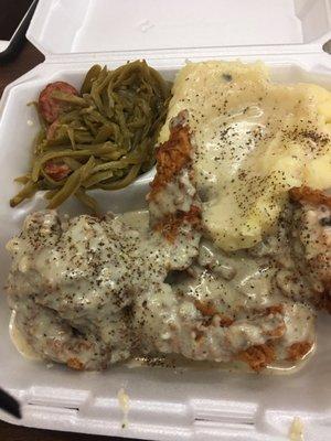 Chicken fried chicken with gravy all around, mashed potatoes & green beans seasoned with onions and sausage.