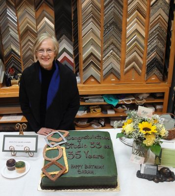 Sara Munro, Owner, with Frame corners and Anniversary Cake