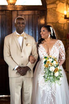 Father walking bride down the aisle during wedding ceremony