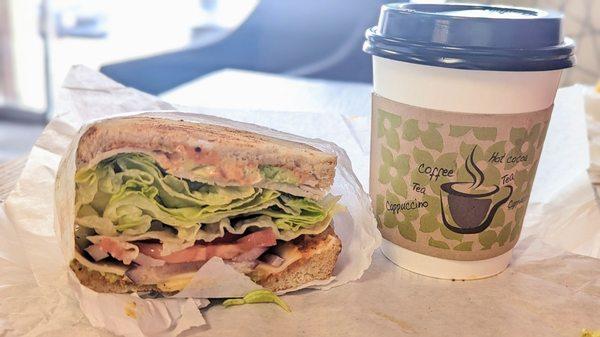 Tasty avocado turkey sandwich on sourdough & a delicious Cuban coffee latte sweetened with lechera.