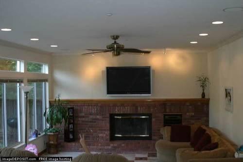 Mounted TV above fireplace.  Wires and equipment concealed.