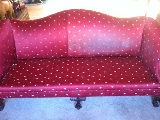 Right side shows before and left side shows after on this red love-seat