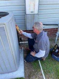 SERVICE MAN CHECKING OUT AC UNIT