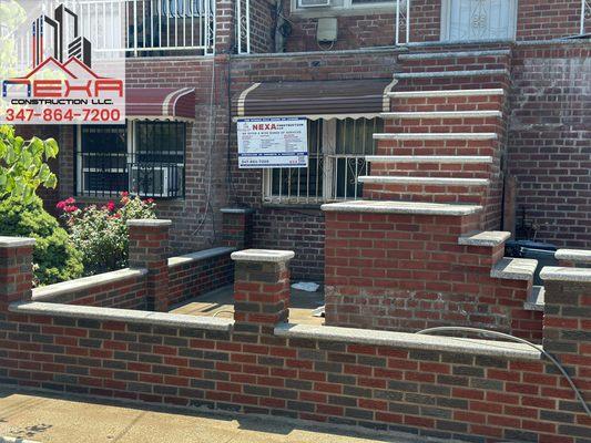 A complete view of beautifully blended mixed brick fence and steps.