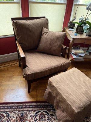 Chair and ottoman with throw pillow.