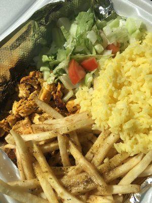 Chicken shawarma with salad, rice and fries.