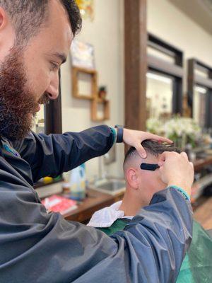 Straight razor meticulously used for a detailed fade.