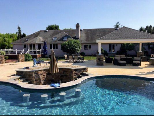 Sunken bar, stone work, patio, and pavilion pillars all by Unique-Crete