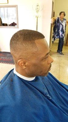 A students finished bald Fade.