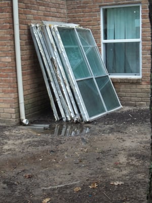 Stack of old windows outside someones apt. nice view....