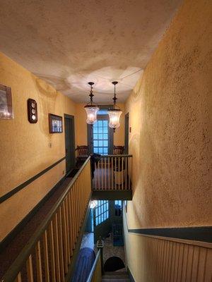 Standing at the top of the steps, looking toward second floor rooms.