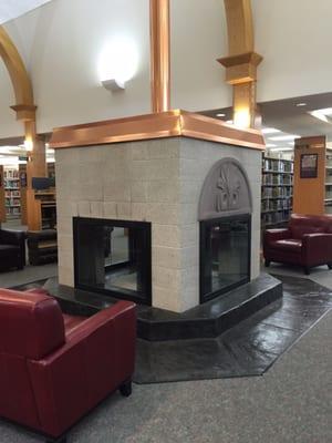 Ah, a cozy fireplace to warm by with a book that carries us some where warm in the Winter months.