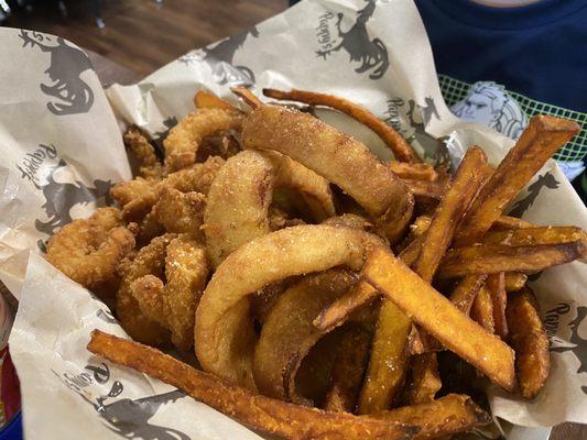 Fried shrimp with sweet potato fries and onion rings.