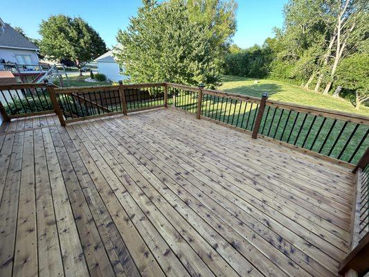 Our specialty - Pecan Oil stained Red Cedar deck boards with black accents and hardware.