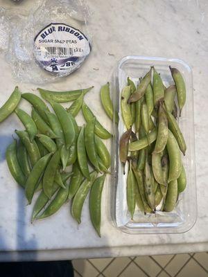 Good snap peas layered on top of rotten ones