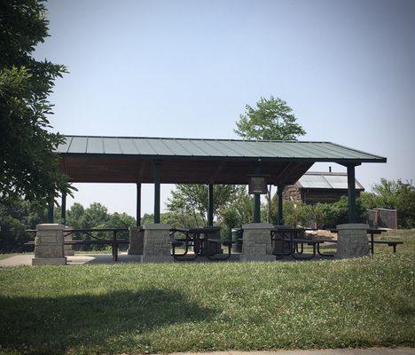 Picnic shelters like this typically have restrooms near them (behind in this photo).