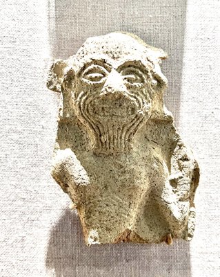 I think this is a depiction of Humbaba, the ferocious beast that is Gilgamesh's nemesis