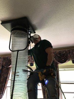 Removing all the dust and dirt from the vent using duct vacuum cleaner