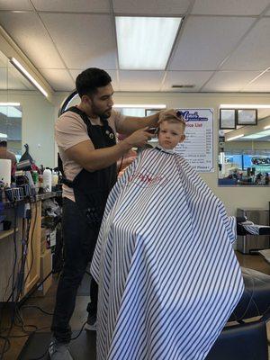 Sergio cutting my son Oliver's hair.