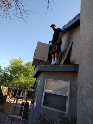 A swamp cooler being serviced