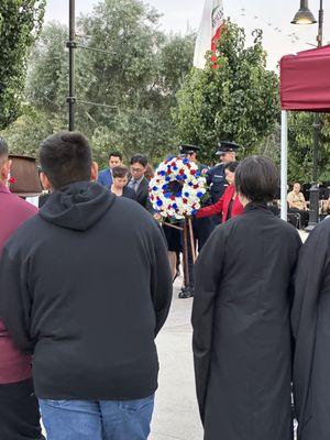 Moving the wreath in front of the steel beam 9/11 memorial