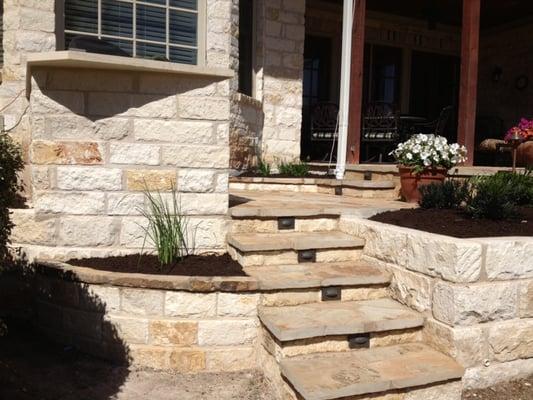 Stone stairs, planters, and patios with inlaid lighting.