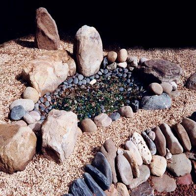 This faux pond of rocks, cobbles and tumbled glass is a small part of a large rock garden.