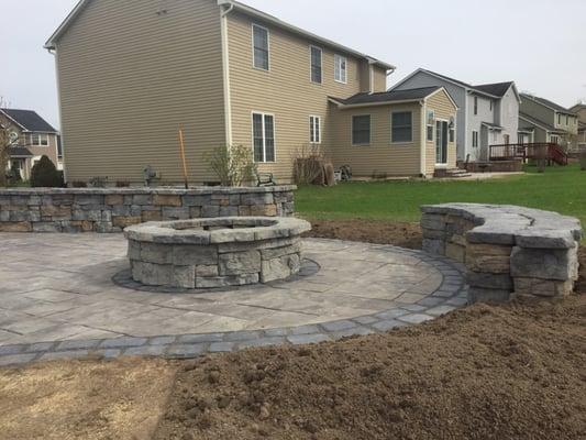 Patio with fire pit, seating wall, and planter wall