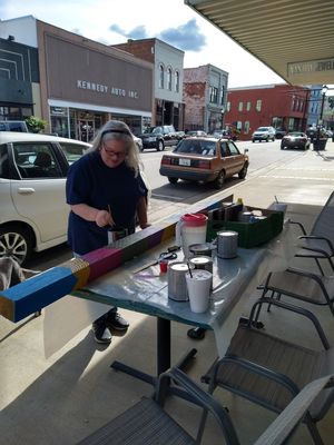 The Southern Gals working on the Main Street wayfinder signs in a downtown Elkin beautification project.