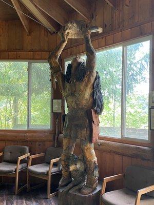 One of the awe inspiring sculptures in a building filled with picnic tables and chairs where people can eat or wait for the tour.