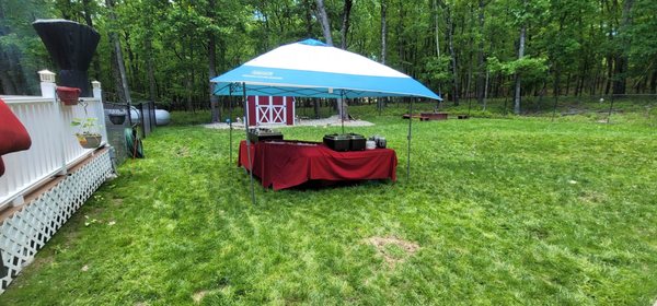 Serving tent and table being set up complete with ice trays to keep the salads cold and hot trays for the hot food!