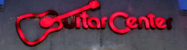 Guitar Center logo at night.