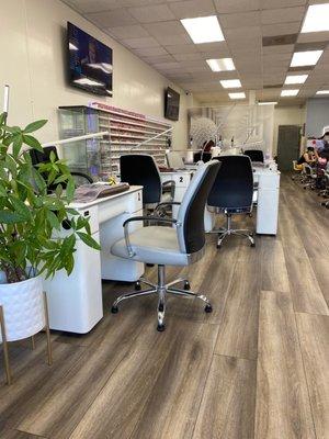 Left side of salon. Colors. Nail tables. 2 TVs.