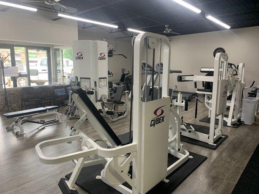 gym space (lots of open floor space, free weights, and TRX to the left of this picture)