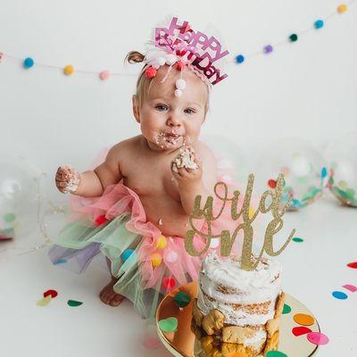 Colorful rainbow baby smash cake session with cake everywhere!