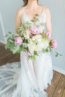 Bride holding flower bouquet.