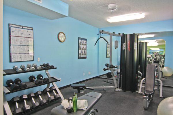 24-hour fitness center with free weights, cardio machines, and weight machines.