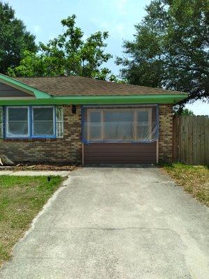 Priming and painting brick home.