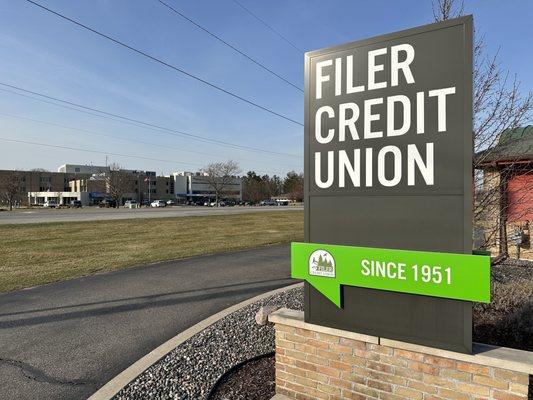 Front exterior sign facing outward across the street towards the hospital at Filer Credit Union - Parkdale Location in the spring