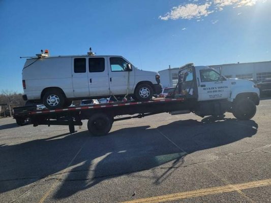 Rollback hauling a van