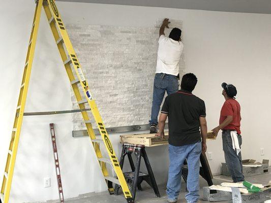 Preparing stack stone wall for decoration in store