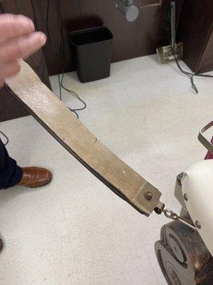 Old fashioned leather strap to sharpen straight razors