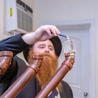 Rabbi Pewzner  lighting the Chanukah  menorah.