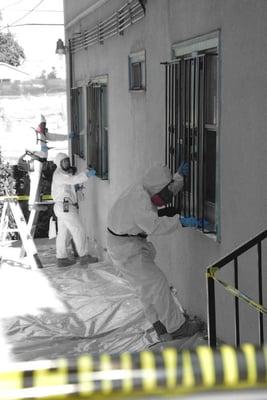 Technicians performing Lead abatement on exterior windows in Los Angeles Rehab project.