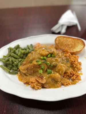 Étouffée with shrimp and catfish over jambalaya rice