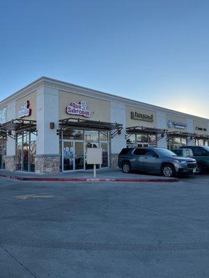 Outside. Que sabrosas is on the corner of a strip mall.